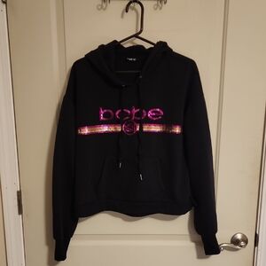 Bebe Sport Black Hoodie with Vibrant Pink and Shimmering Gold